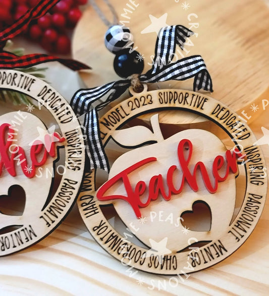 Handmade wooden apple ornament with red 'Teacher' text, black ribbon, and engraved details, perfect teacher gift.