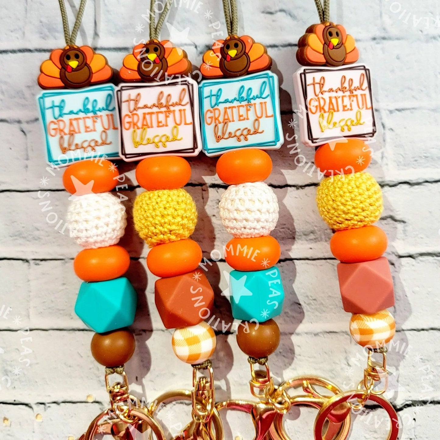 Handmade Thanksgiving lanyards with turkey charms, orange, yellow, teal and brown beads