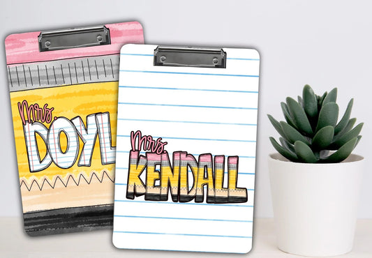 Handmade colorful personalized teacher clipboards, notebook and lined paper designs, next to a green succulent plant