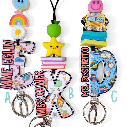 Handmade colorful teacher lanyards with custom names, apples, stars, and school buses by Mommie Peas Creations