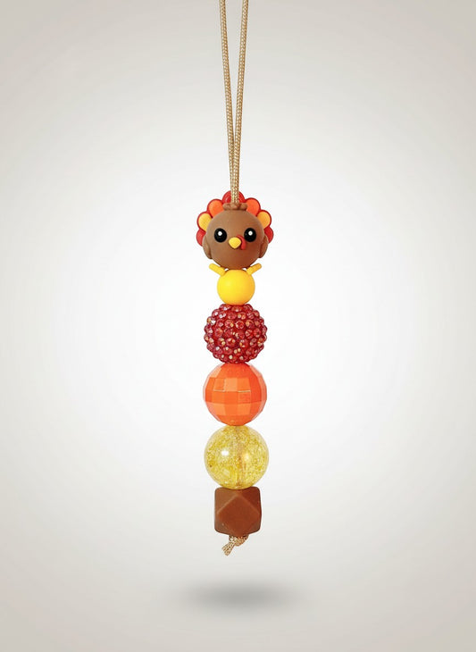 Mommie Peas Creations Thanksgiving Turkey beaded lanyard with red, orange, and yellow beads and a 3D turkey charm.