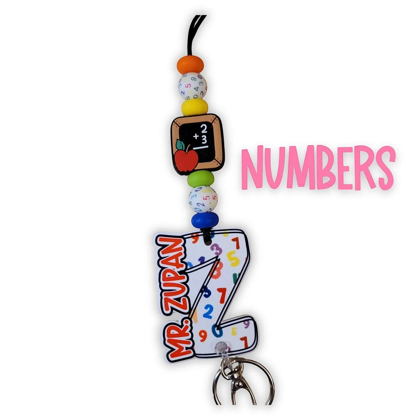 Mommie Peas Creations math teacher lanyard with acrylic charms featuring a chalkboard, apple, and a large 'Z' with numbers and 'MR. ZUPAN'.