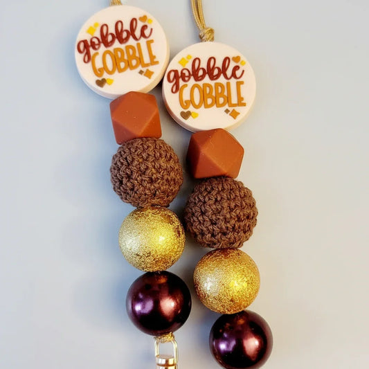 Handmade gifts with brown, gold, and purple beads, 'gobble gobble' charms, autumn colors
