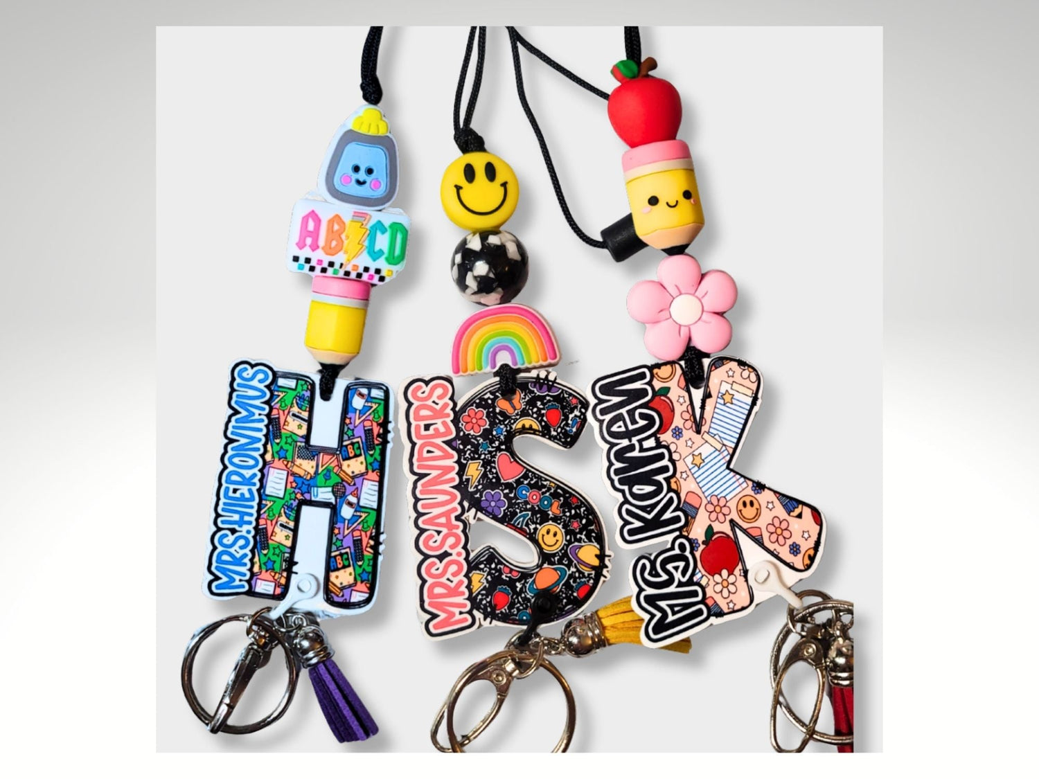 Personalized teacher lanyards with colorful beads, custom name charms, and retractable badge reels