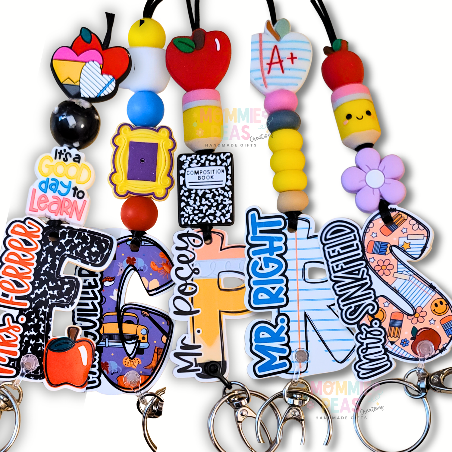 Handcrafted teacher lanyards from Mommie Peas Creations featuring diverse designs like the red apple, composition notebook, and pencil themes with personalized name charms and colorful silicone beads.
