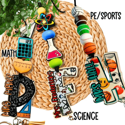 Colorful handmade teacher lanyards for math, science, and PE with unique charms and beads.