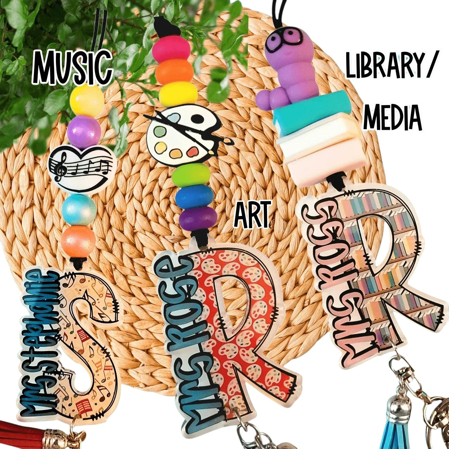 Colorful handmade teacher gifts with custom beads and charms for music, art, library themes.