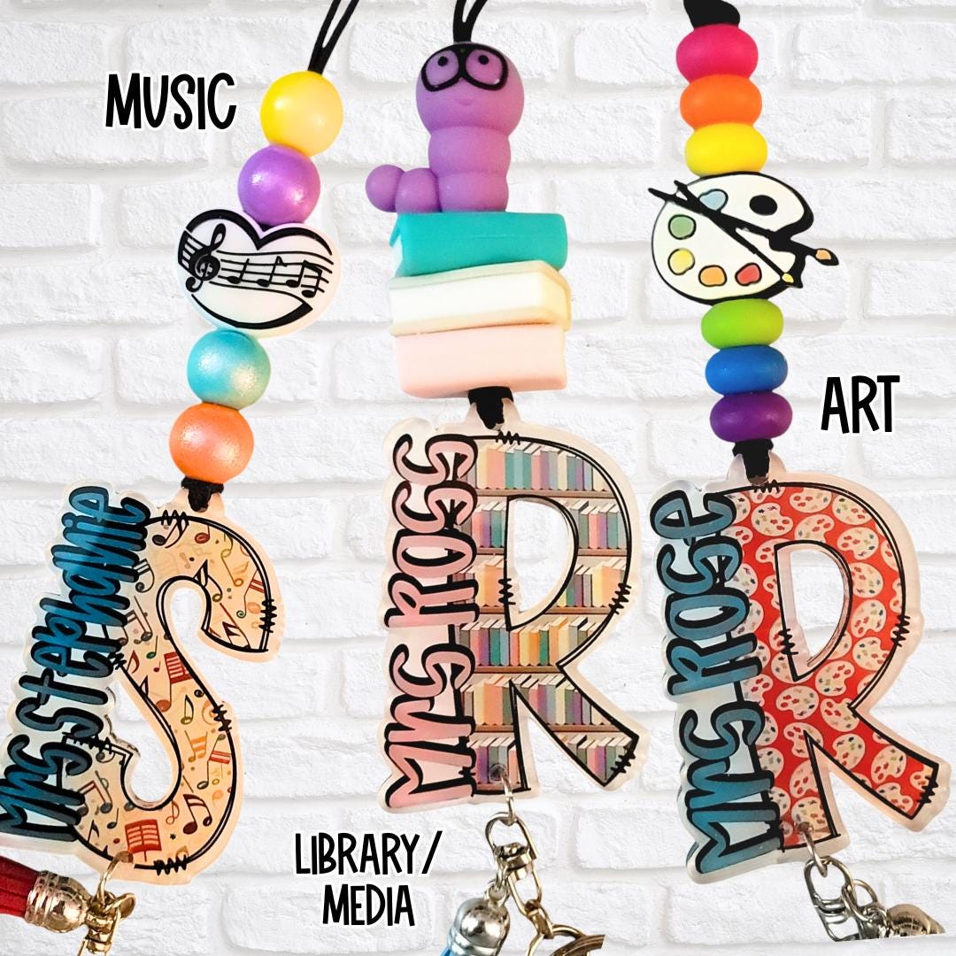 Music, library, and art-themed teacher lanyards with vibrant beads and customized monogram letters for Mrs. Stephanie, Mrs. Ross, and Ms. Rose.