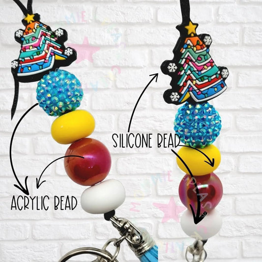 Colorful handmade beaded lanyard with festive Christmas tree charm, blue, yellow, red, and white beads.