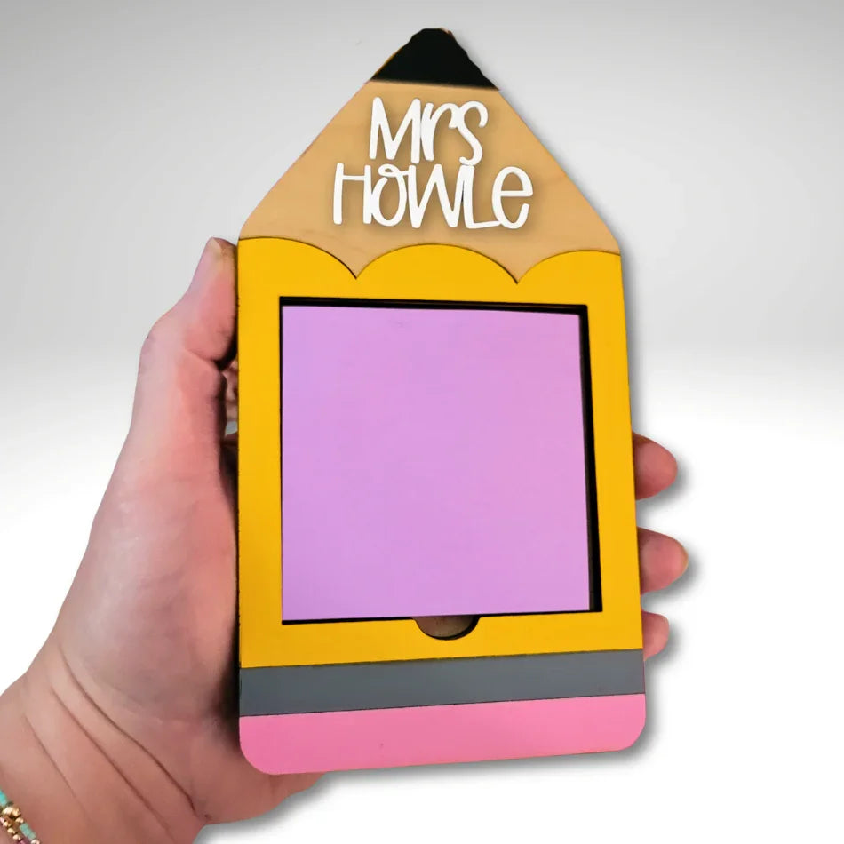 Hand holding a handmade yellow pencil-shaped notepad holder with pink and grey accents, personalized teacher gift