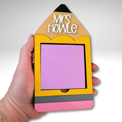 Hand holding a handmade yellow pencil-shaped notepad holder with pink and grey accents, personalized teacher gift