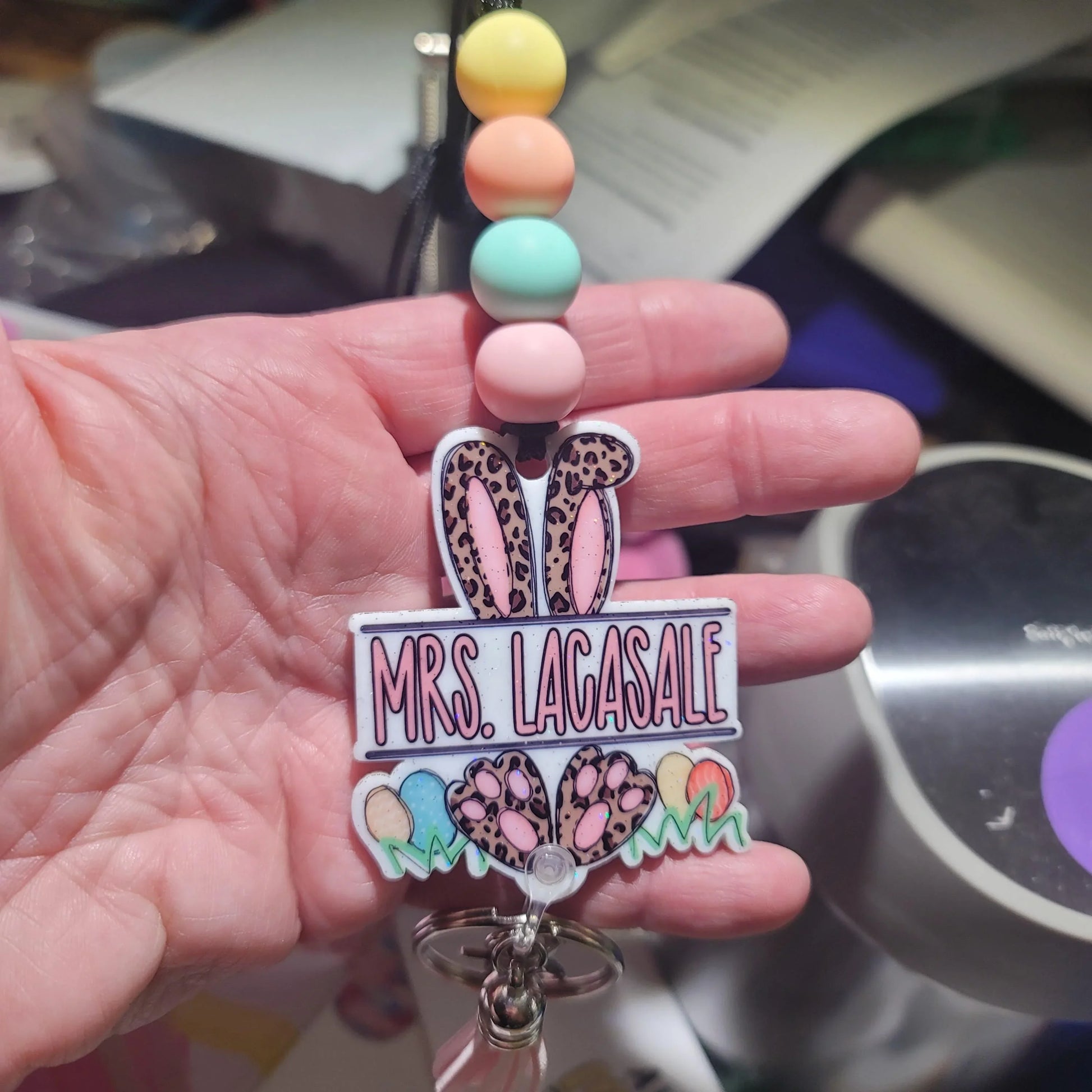 Handmade pastel beaded badge reel with leopard bunny ears, Easter eggs, and custom name