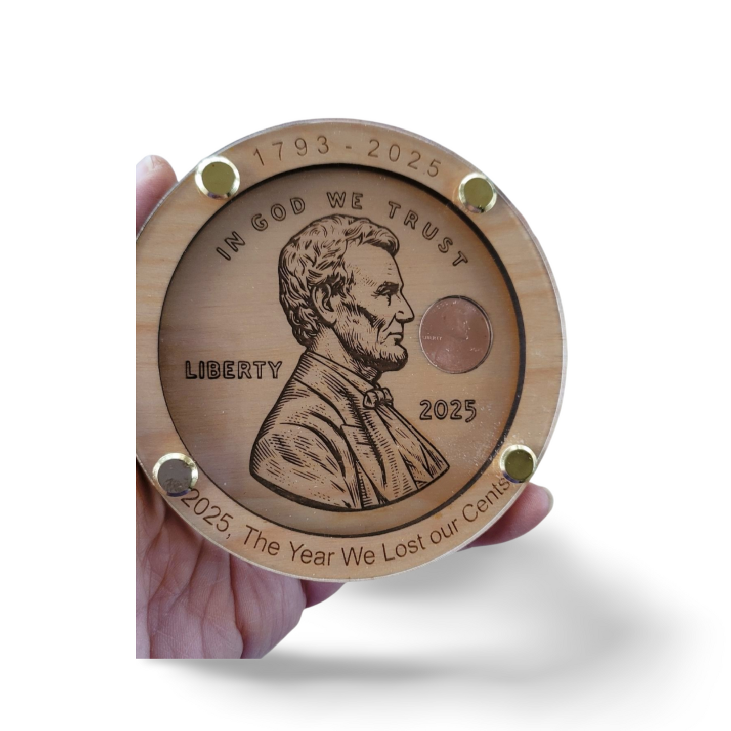 Hand holding a round, copper and wood coin plaque with engraved Abraham Lincoln design, handmade gift.