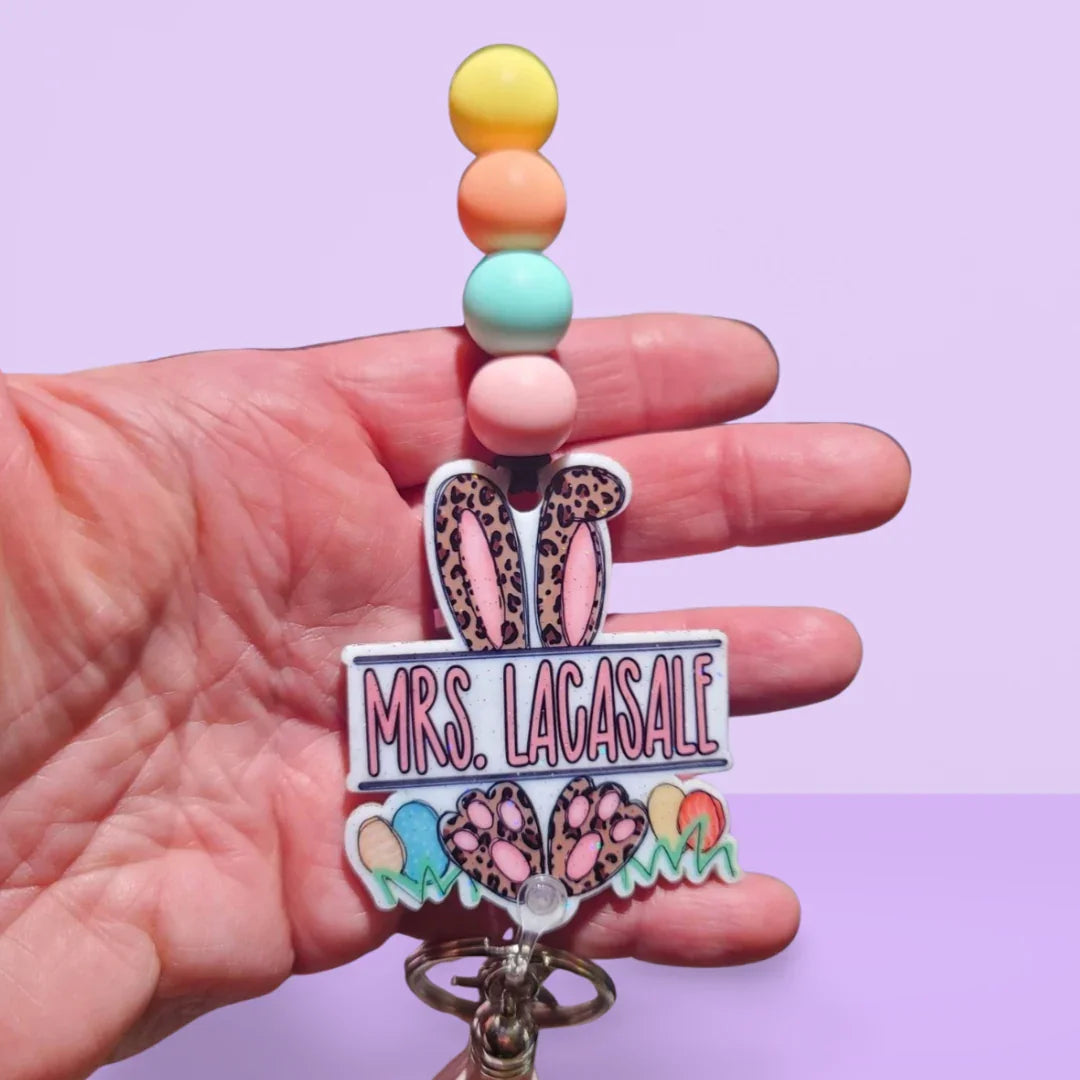 Handmade pastel beaded keychain with pink leopard bunny ears and custom name tag