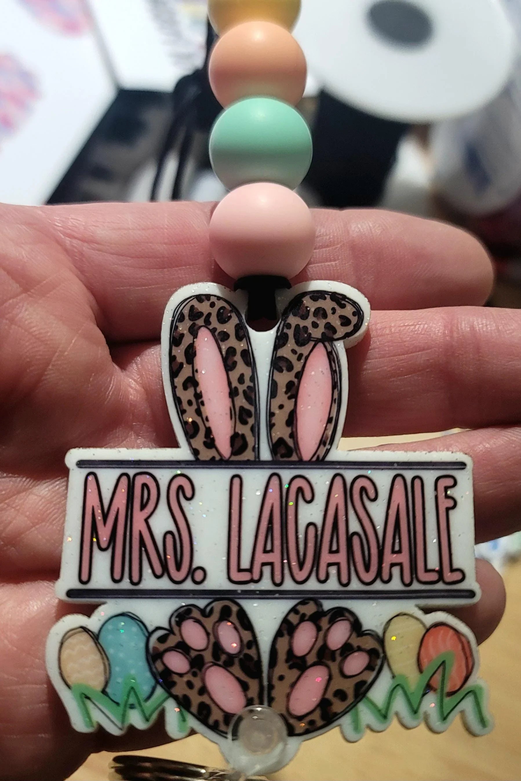 Handmade pastel beaded lanyard with leopard print bunny ears, Easter eggs, and custom name charm