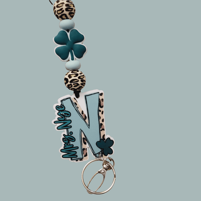 Stylish keychain with leopard print beads, teal clover, and large blue letter N charm