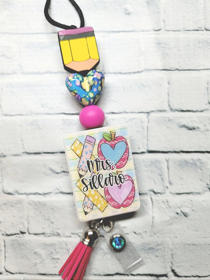 Handmade colorful teacher badge reel with pink, yellow, and blue accents, personalized gift