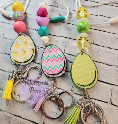 Colorful keychains with Easter egg pendants, geometric and beaded designs, and tassel accents