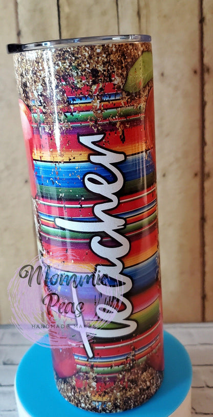 Rustic tumbler with colorful striped pattern and white Tacoma text on wooden background