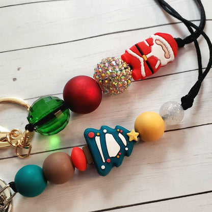 Christmas-themed keychains featuring Santa, holiday tree charms, and colorful decorative beads