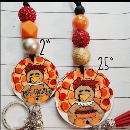 Two handcrafted turkey keychains with beads, one labeled Mrs. Bradley, measuring 2 and 2.5 inches