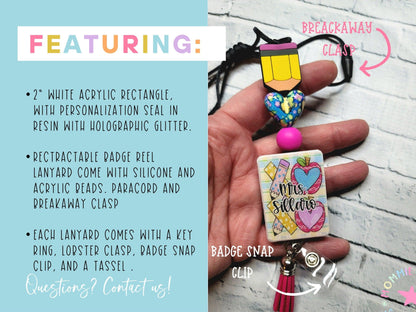 Hand holding a personalized retractable badge reel lanyard with a pencil clip, colorful heart bead, custom name tag, and pink tassel clip