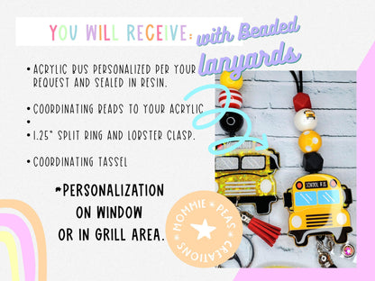 Two personalized acrylic school bus keychains with colorful beaded lanyards and tassels on a gray brick background