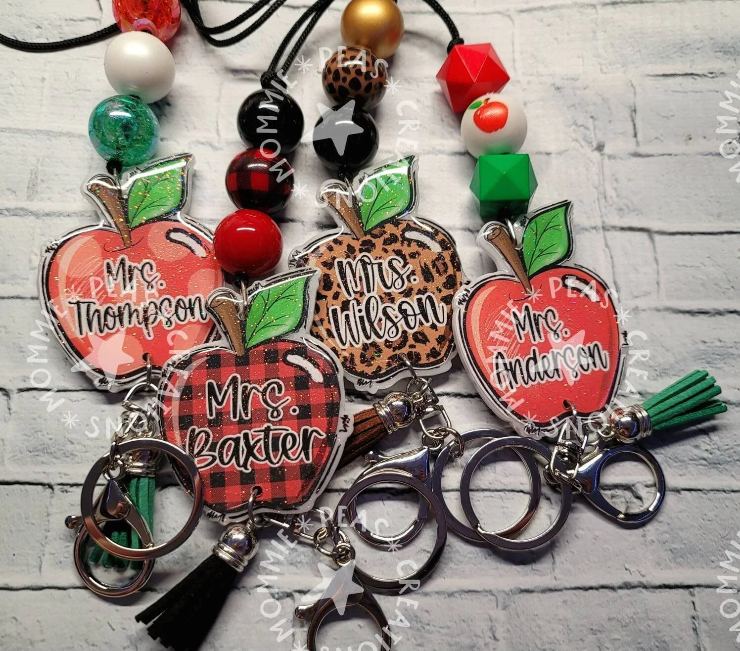 Handmade personalized apple-shaped lanyard keychains in red, plaid, and leopard print with colorful beads, unique custom teacher gifts.