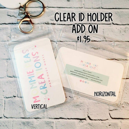 Clear vertical and horizontal plastic ID holders with keyring on white brick background, labeled $1.95 add on