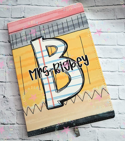 Personalized notebook cover with large letter B and name Mrs. Rigbey in colorful, school-themed design