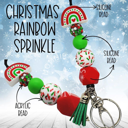 Christmas Rainbow Sprinkle keychain with silicone and acrylic beads, rainbow bead, green tassel on snowflake background