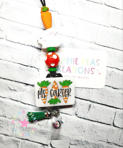 Custom badge reel with carrot beads, white bunny charm, and name tag reading Ms. Carter
