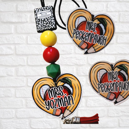 Custom teacher keychains with pencil heart design, apple, and names Mrs. Yozman and Mrs. Peckenpaugh