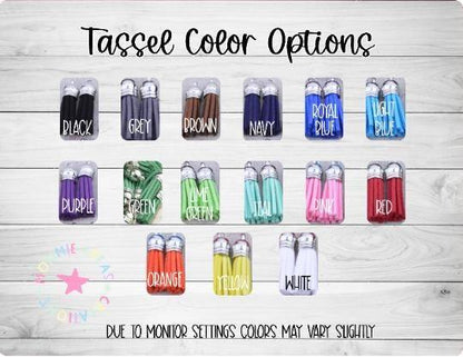 Tassel color options displayed in rows on wood background with color names including black, grey, brown, navy, royal blue, light blue, purple, green, lime green, teal, pink, red, orange, yellow, white