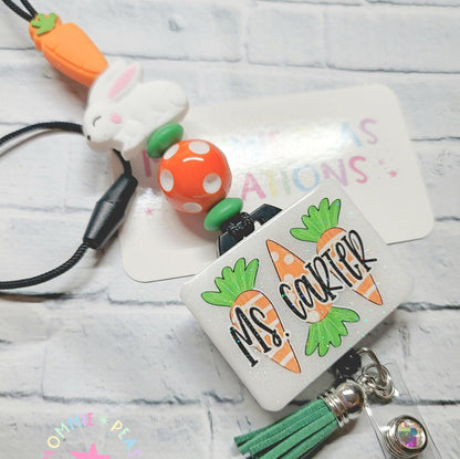 Custom glitter badge reel with carrots, rabbit charm, orange polka dot bead, and green tassel