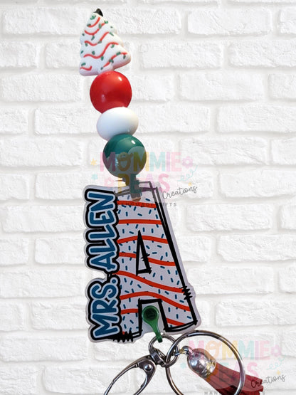 Christmas-themed keychain badge reel with name Mrs. Allen and festive beads including a decorated tree