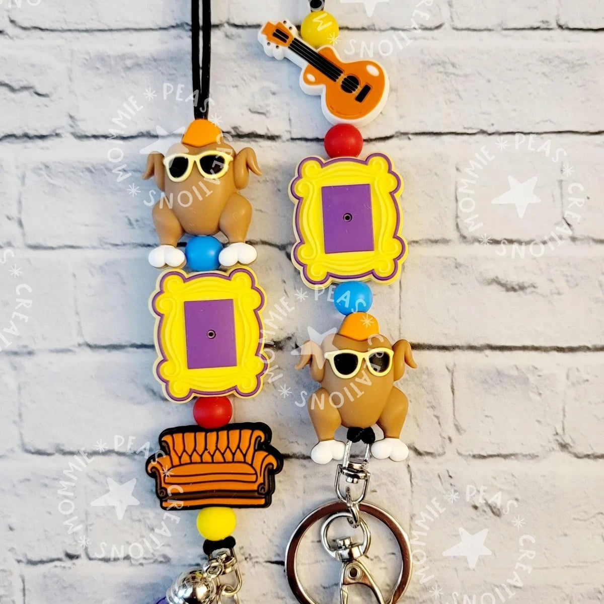 Mommie Peas Creations Fall Turkey Lanyard with Friends-themed charms: turkey, picture frame, couch, and guitar. Features silicone beads and a breakaway clasp.