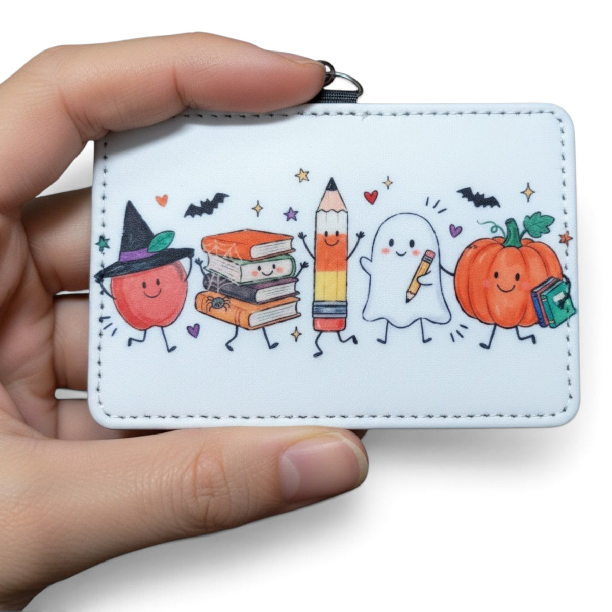 Mommie Peas Creations horizontal PU leather ID badge holder with cute Halloween doodle print of ghosts and pumpkins.