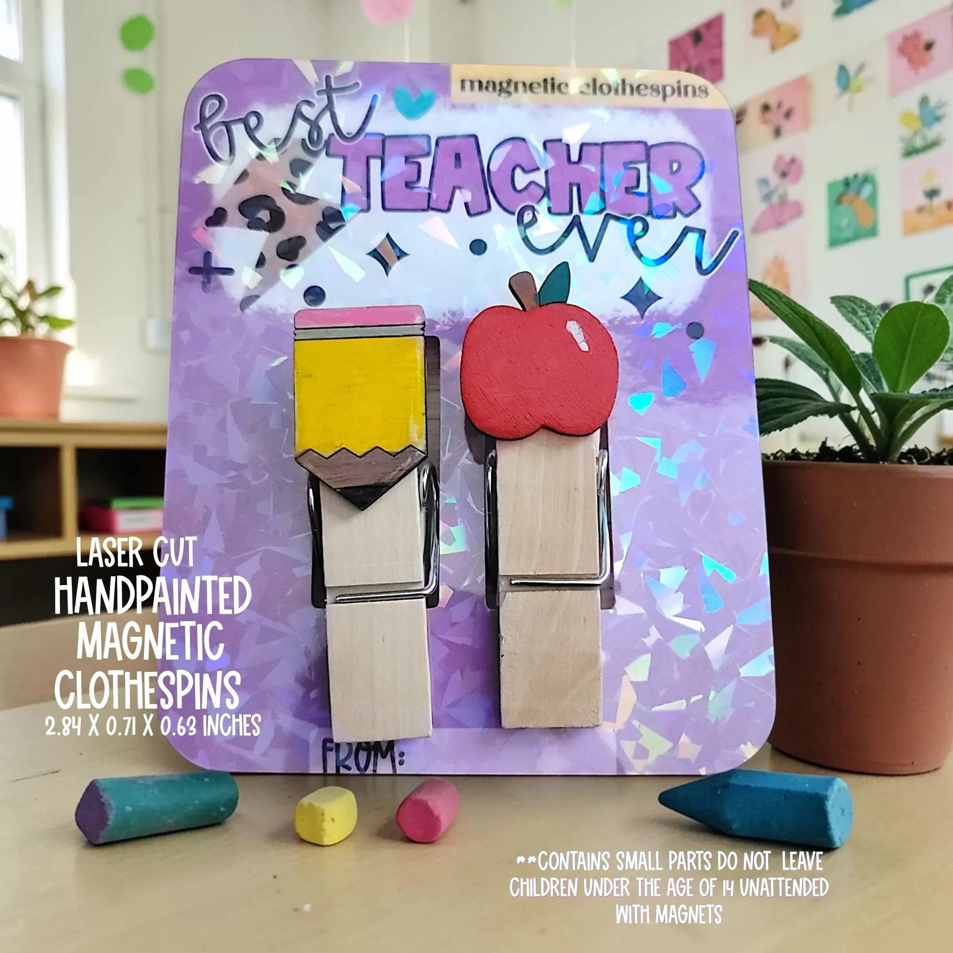 Mommie Peas Creations hand-painted wooden magnetic clothespins featuring a pencil and an apple design, perfect for teachers.