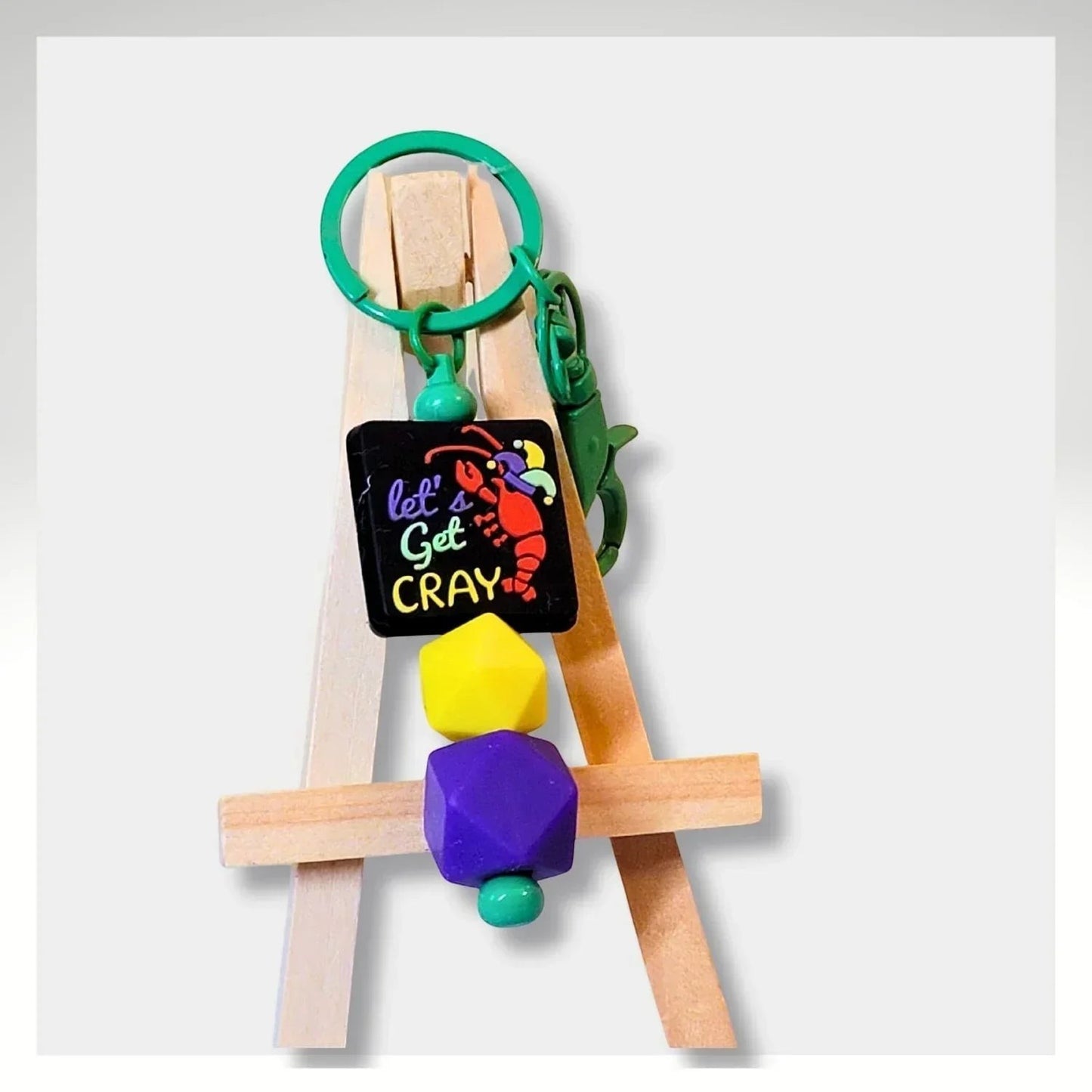 Mommie Peas Creations Mardi Gras keychain with crawfish charm, purple, green, and yellow beads.