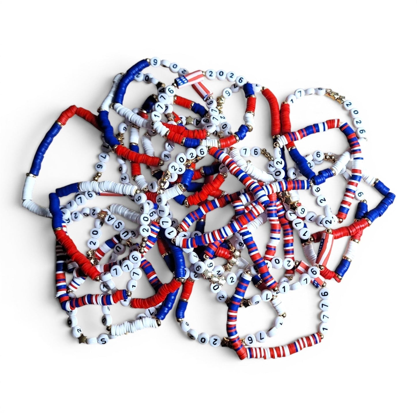 Mommie Peas Creations patriotic beaded bracelet collection with red, white, and blue vinyl discs, spelling USA 2026, and gold star charms.
