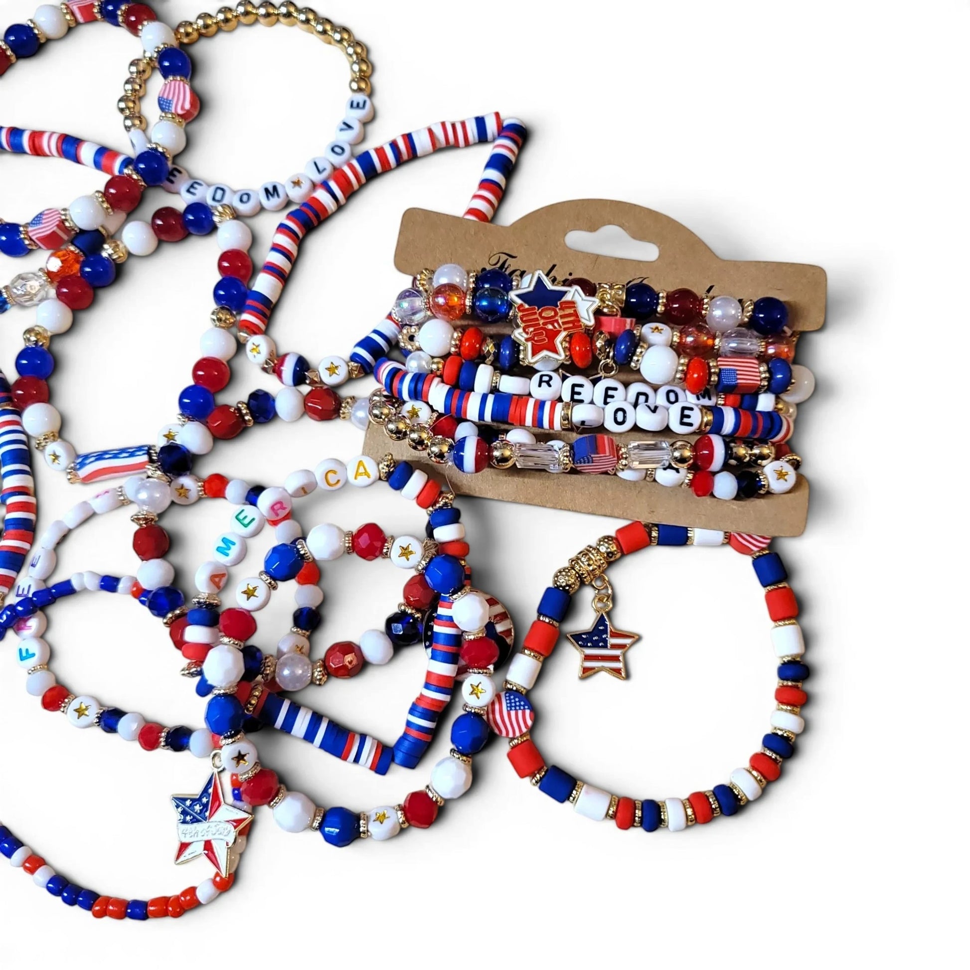 Mommie Peas Creations patriotic beaded bracelets with red, white, blue vinyl discs, USA/2026 letter beads, and gold star charms.