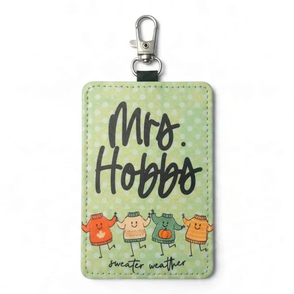 Handmade Mommie Peas Creations green badge holder with 'Mrs. Hobbs' and colorful sweaters.