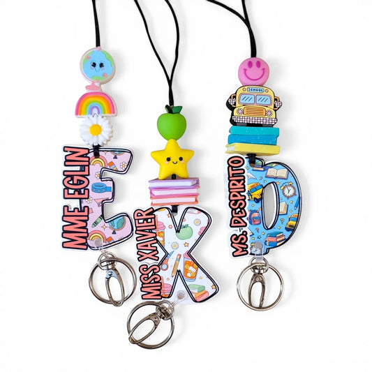 Colorful handmade teacher lanyards with personalized names and fun designs from Mommie Peas Creations