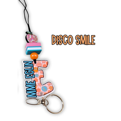 Mommie Peas Creations personalized teacher lanyard with disco smile charm, colorful beads, and custom name tag