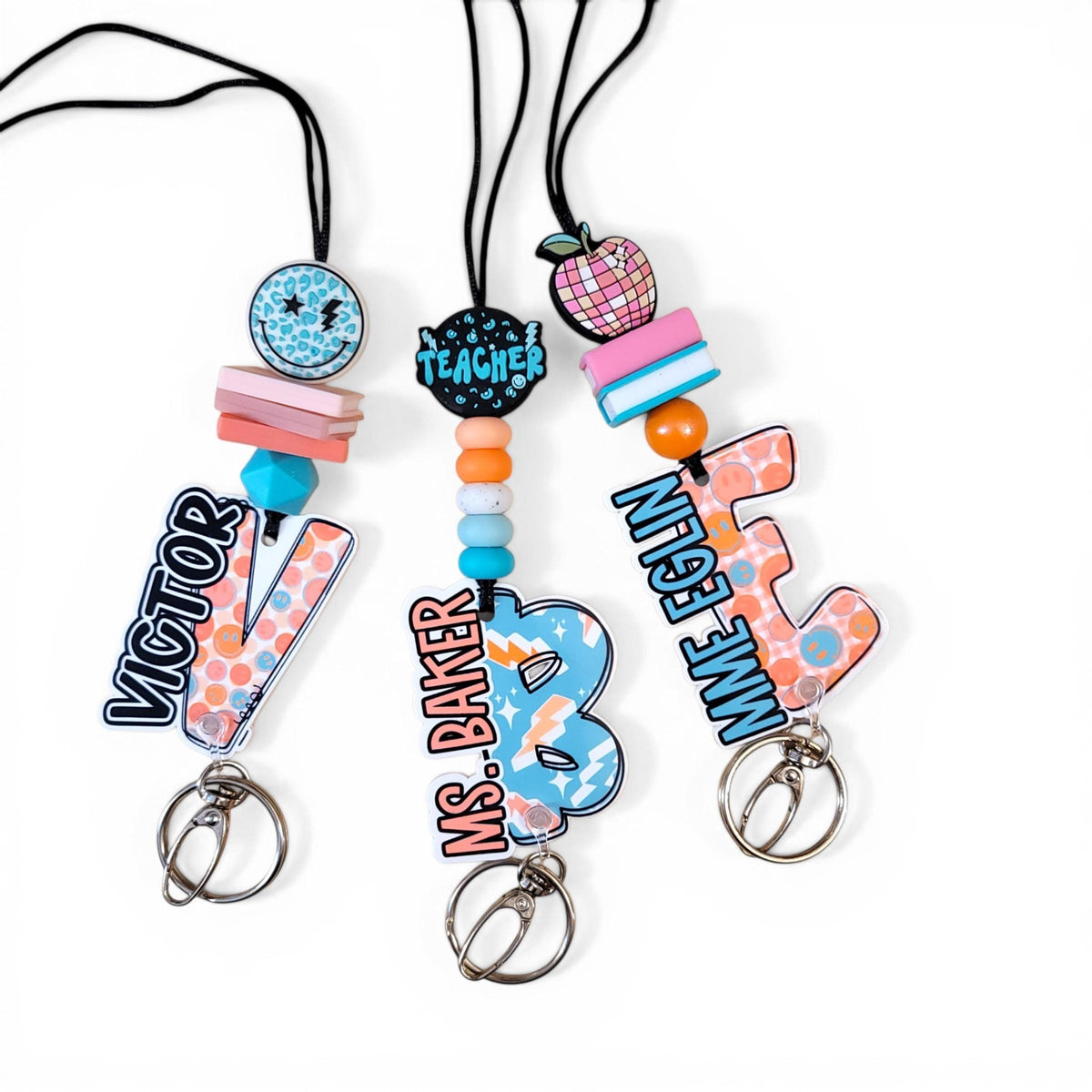Mommie Peas Creations personalized teacher lanyards with colorful silicone beads, custom name charms, and metal clips.