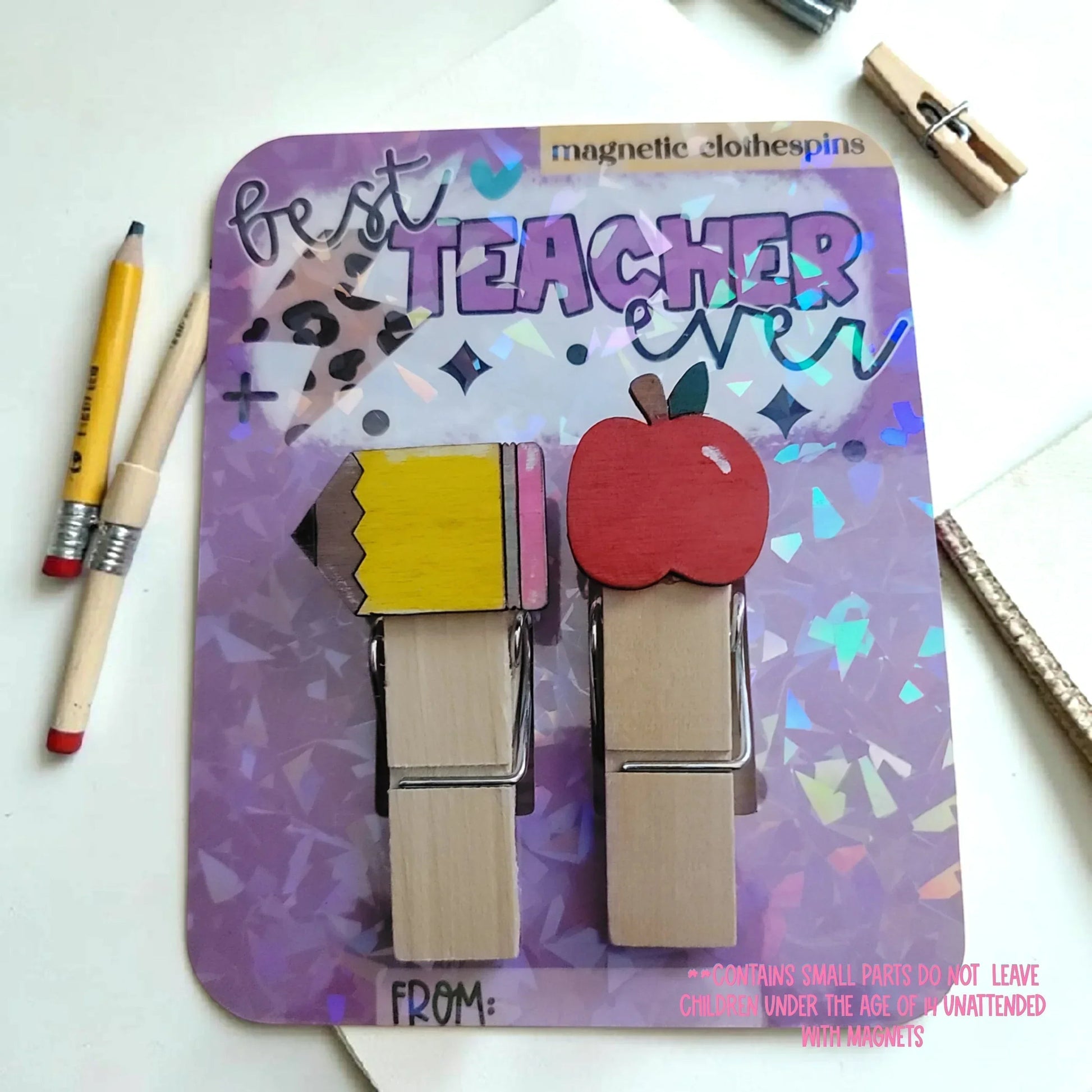 Mommie Peas Creations hand-painted wooden magnetic clothespins featuring a yellow pencil and a red apple design. "Best Teacher Ever" text.
