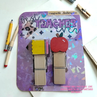 Mommie Peas Creations hand-painted wooden magnetic clothespins featuring a yellow pencil and a red apple design. "Best Teacher Ever" text.