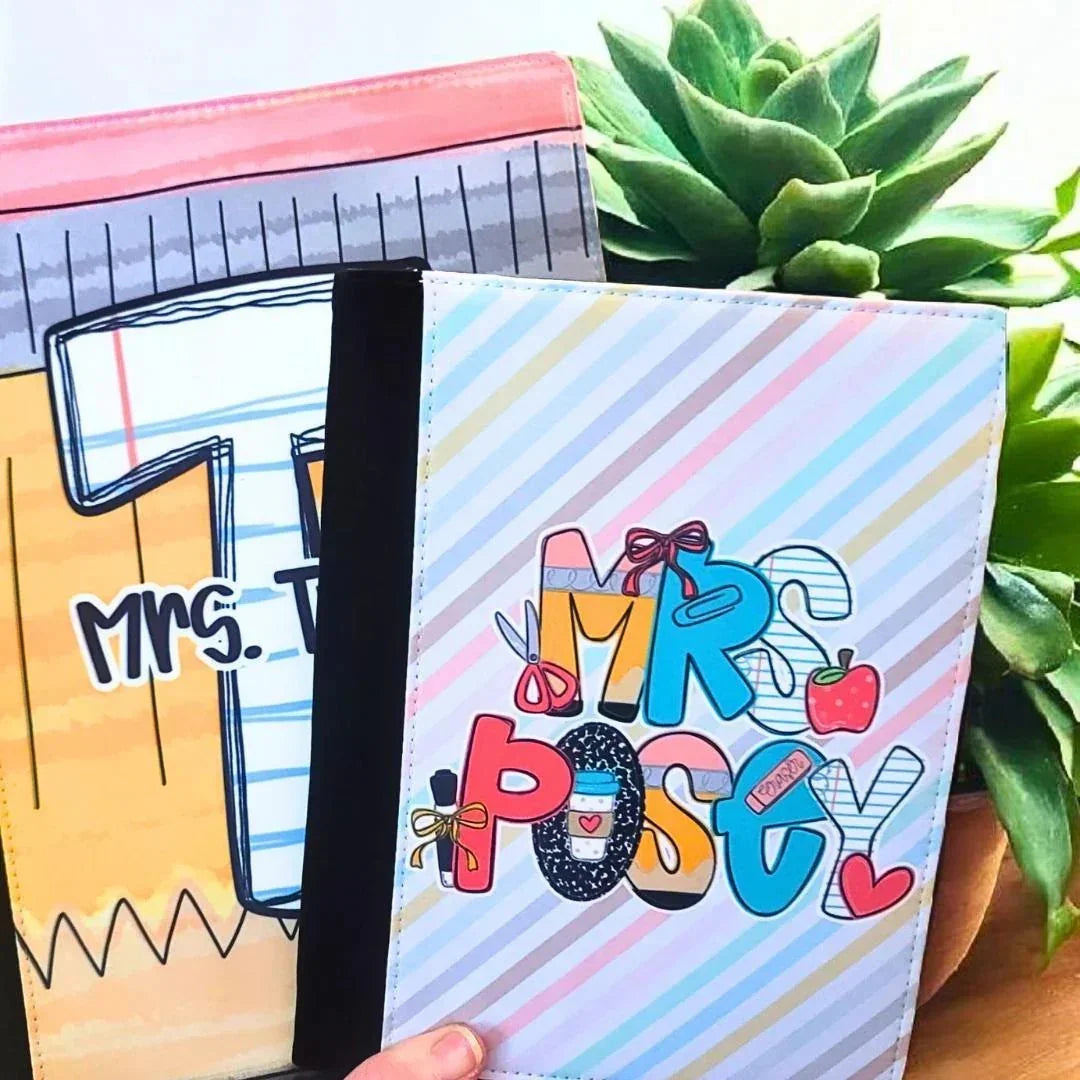 Mommie Peas Creations personalized teacher padfolio with pastel stripes and colorful "Mrs. Posty" lettering featuring school supplies.