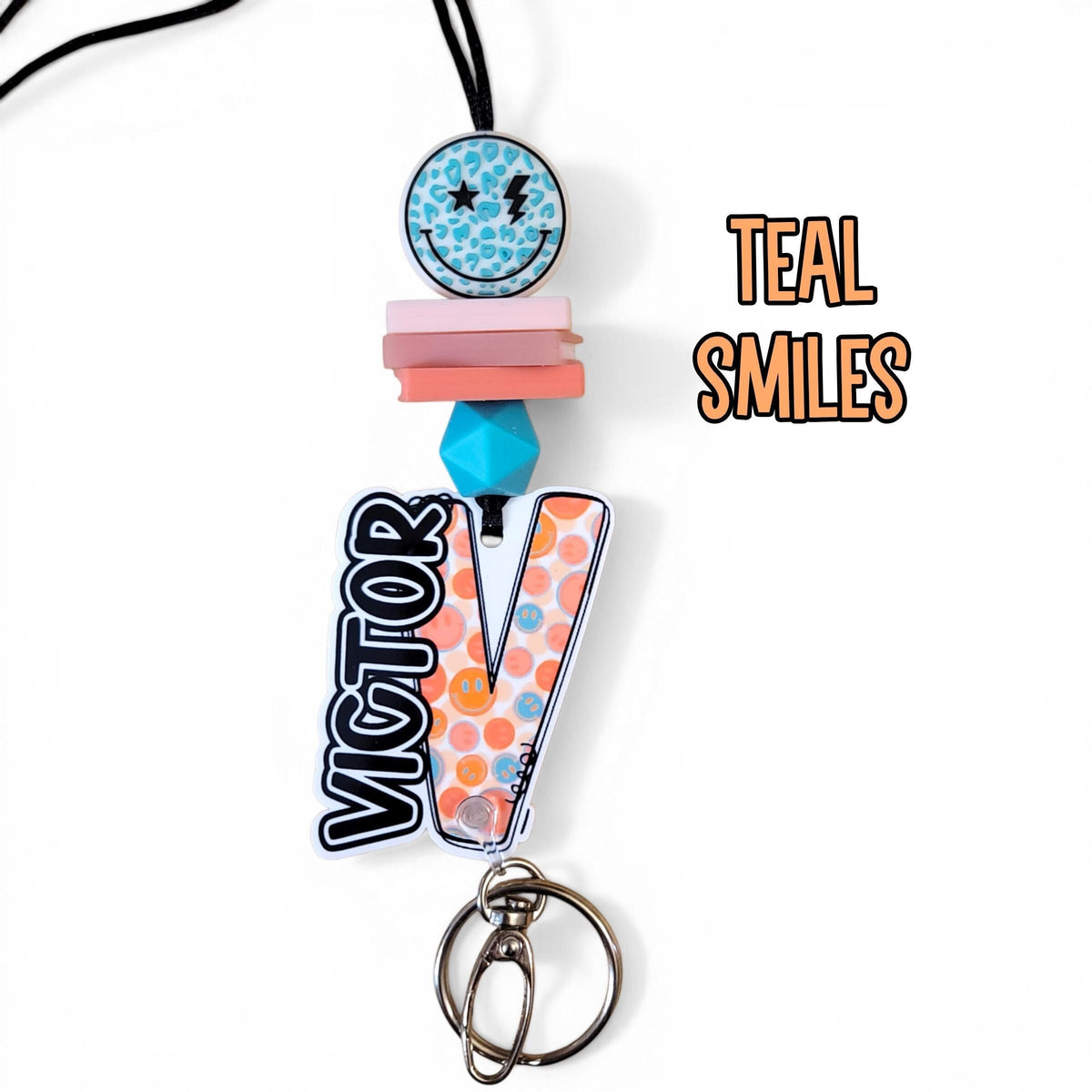 Mommie Peas Creations personalized teal smiley face teacher lanyard with silicone beads and custom name charm